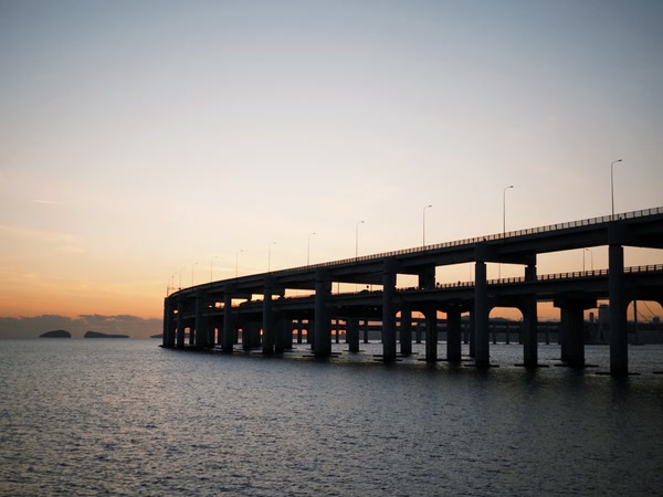 A bridge resting above the evening sea